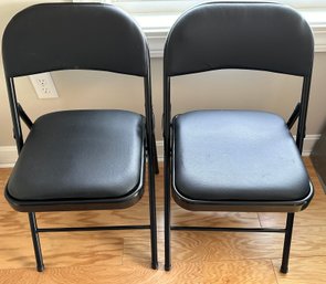 Two Faux Leather Black Folding Chairs - O24