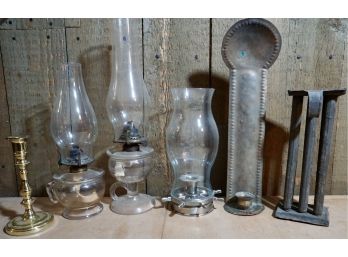 6. PIECE LOT CONTAINING OIL LAMPS, CANDLE STICKS AND MOLDS