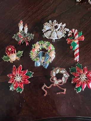 A Group Of Christmas Holiday Ornamental Pins