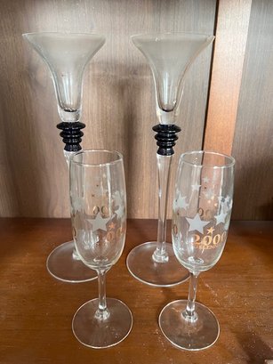 A Apair Of Block Glass Candle Sticks And A Pair Of Millenia Champagne Flutes