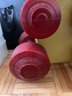 A Set Of 6 Dumb Bell Weights On Rack