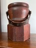 An Early Americana Wood Covered Turned Vessel With Leather Strap