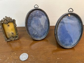 A Pair Of Oval Sterling Silver Photo Frames And A Bronze Diminutive Frame