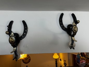 A Pair Of Longhorn Spurs Mounted On Horseshoes