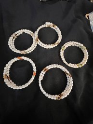 A Group Of 5 Wrap Faux Pearl Bracelets