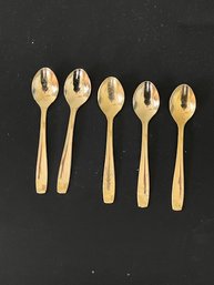 A Group Of Gold Tone Demitasse Spoons