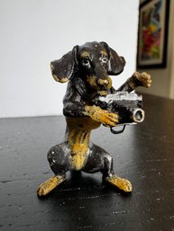 A Vienna Bronze Dachshund Holding A Camera