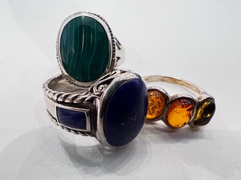 A Group Of Three Sterling Silver Rings With Various Stones, Amber, Malachite And Lapis