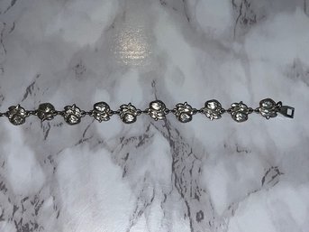 A Double Sided Rose And Saint Bracelet