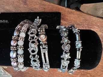 A GROUP OF 6 SILVER BRACELETS NOT ALL STERLING