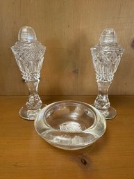 A Pair Of Crystal Salt And Pepper Shakers And A Small Salt Dish