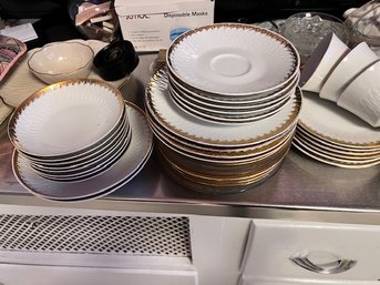 A Group Of Gold And White Dishes Plates, Cups, Some Serving Pieces