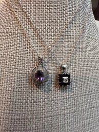 A Pair Of Silver And Amethyst And Stone Necklaces On Silver Chains