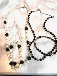 A Pair Of Black And White Bracelet And Necklaces