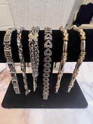 A Group Of 6 Link Bracelets