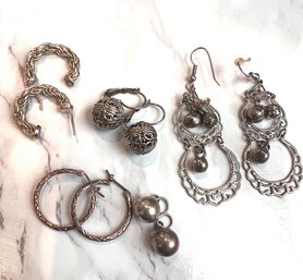 A Group Of  Silver Dangling Pierced Earrings