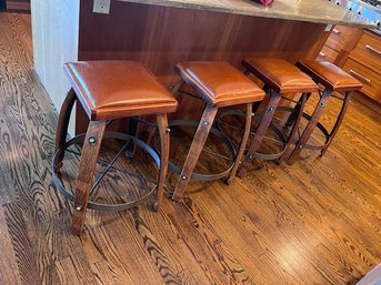 A Group Of 4 Bar Stools In Leatherette And Industrial Finished Metal Bases