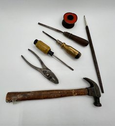 A Group Of Tools Including A Spool Of Copper Wire
