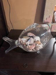 A Glass Fish Bowl Filled With Shells