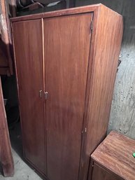 A Solid Wood Armoire With Mirror And Drawers