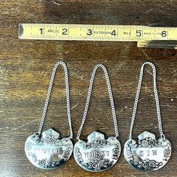 A Group Of Three Liquor Marker Metal