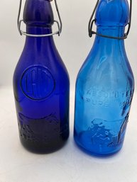 A Pair Of Vintage English Blue Glass Milk Bottles