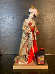 Traditional Geisha Girl With Small Jewelry Box And Hat