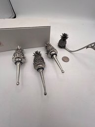 A Group Of Pewter Pineapple Wine Stoppers And A Candle Snuffer ( One Wine Stopper Brand New With Box