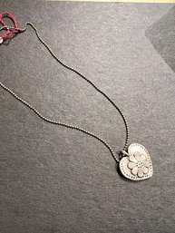 A Silver Heart Necklace Made From A Silver Quarter
