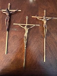 A Group Of Three Brass Crosses