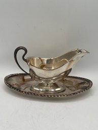 A Silver Plate Gravy Boat With Tray