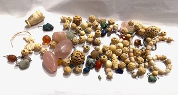 A Group Of Carved Beads And Stones