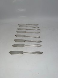 A Group Of 8 Silver Plate Butter Knives