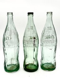 A Group Of 3 Vintage Coca Cola Bottles