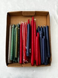A Group Of Taper Candles Red Green Navy