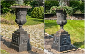 PAIR MONUMENTAL CAST IRON URNS ON PLINTH