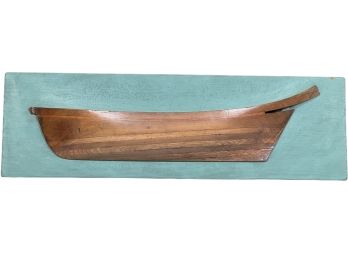 ANTIQUE WOODEN HALF HULL ON PAINTED BACK BOARD