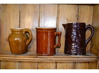 Three Assorted Brown Pitchers