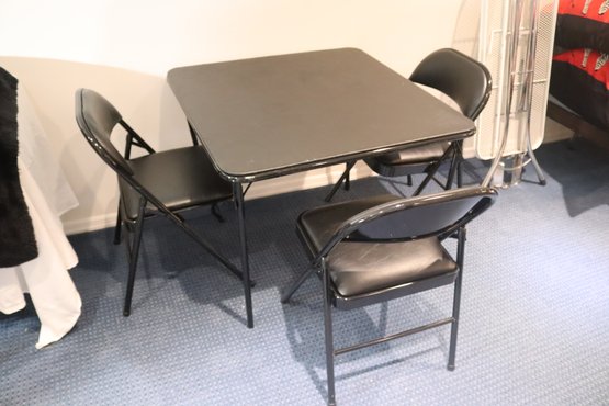 3 Folding Chairs And A Table