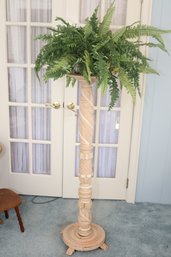 Tall Pedestal With Faux Fern Plant On Top.