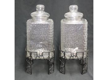 Pair Of Glass Beverage Dispensers With Spouts On Metal Bases