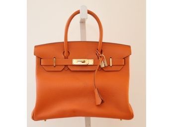 Orange Pebbled Leather Handbag With Gold Lock