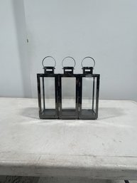 A Trio Of Small Black Metal Lanterns