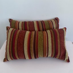 A Pair Of Multi Colored Striped Throw Pillows