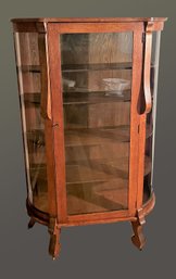 Vintage Victorian Oak Curio Cabinet Featuring Curved Glass, Carved Lion Paw Feet With Wooden Wheels