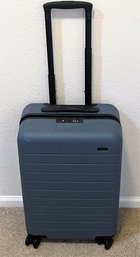 The Away Hard Case Rolling Suitcase With International Power Adapters