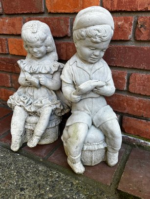 Two Concrete Statues Boy & Girl