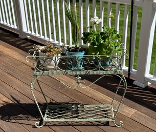 A Painted Metal Plant Stand With 3 Potted Plants