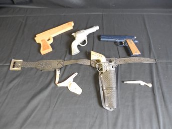 Toy Gun Lot Including Cap Gun, Wooden Gun, And Other Related Items.