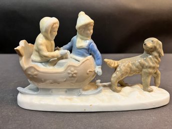 Porcelain Figure Of Children In Sled With Dog